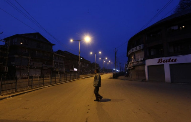 an indian policeman patrols a deserted road during a curfew in srinagar on february 11 2013 photo reuters file an indian policeman patrols a deserted road during a curfew in srinagar on february 11 2013 photo reuters file