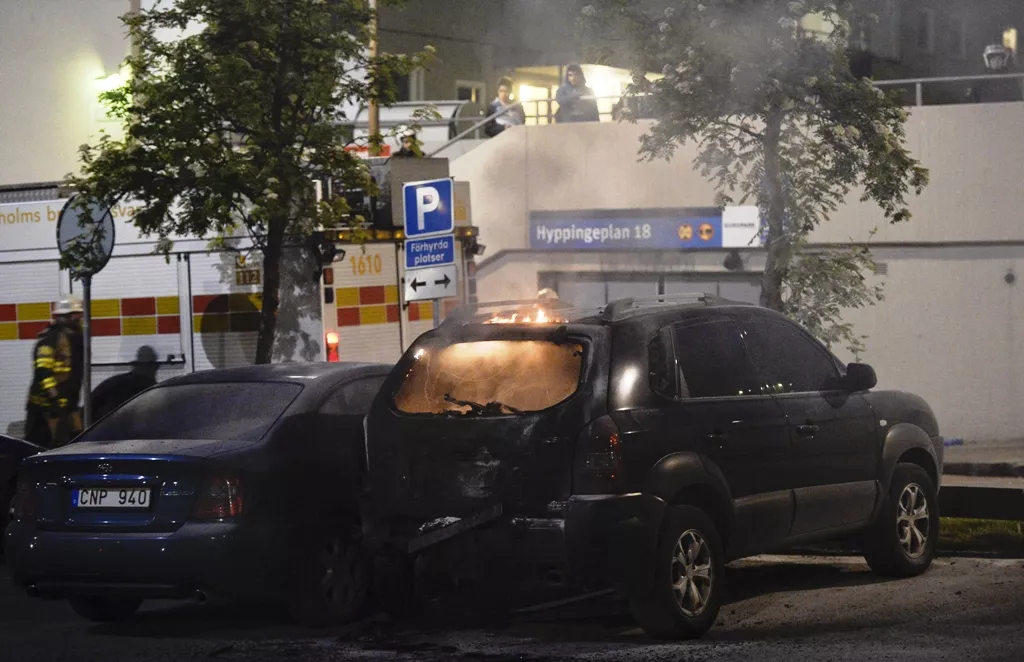 firemen extinguish a burning car in the stockholm suburb of tensta after youths rioted in few different suburbs around stockholm and sweden on may 24 2013 photo afp firemen extinguish a burning car in the stockholm suburb of tensta after youths rioted in few different suburbs around stockholm and sweden on may 24 2013 photo afp