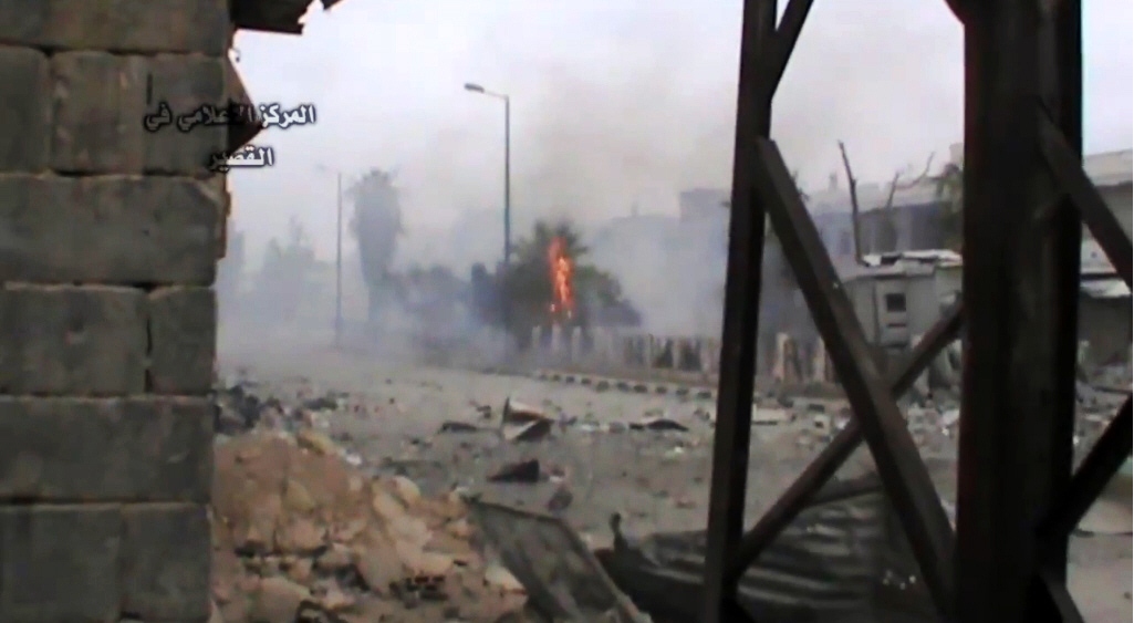 a image grab taken from a video uploaded on youtube by al qusayr media centre on may 24 2013 shows smoke rising from the site of an alleged rocket attack in the city of qusayr photo afp