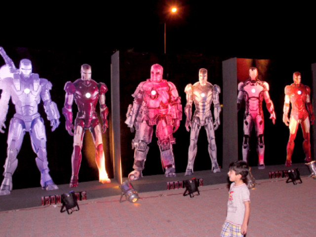 a child gazes at a display of cut outs of various iron man suits featured in the movie a promotional poster for iron man 3 photo express a child gazes at a display of cut outs of various iron man suits featured in the movie a promotional poster for iron man 3 photo express