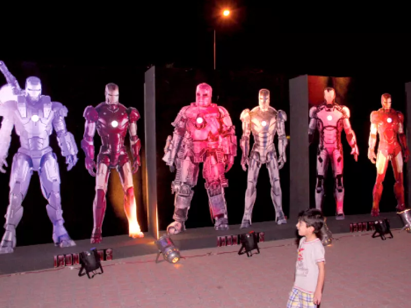 a child gazes at a display of cut outs of various iron man suits featured in the movie a promotional poster for iron man 3 photo express a child gazes at a display of cut outs of various iron man suits featured in the movie a promotional poster for iron man 3 photo express