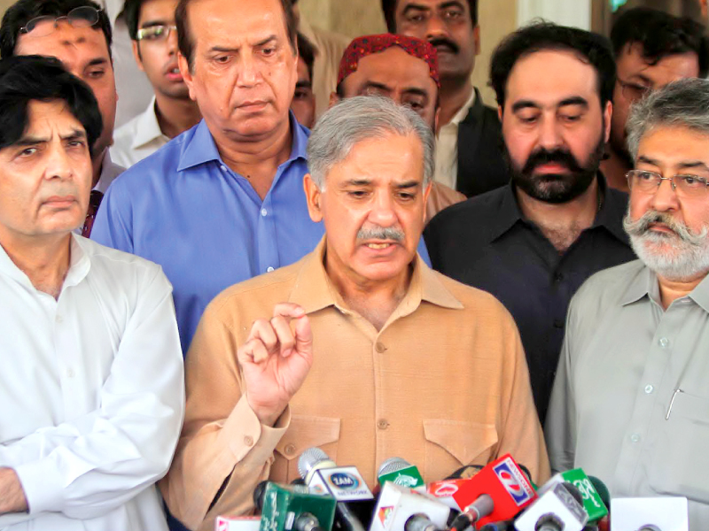 pml n leader shahbaz sharif flanked by pml f chief pir pagara talking to media photo inp