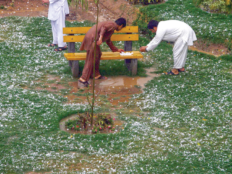 people collect hailstones after a heavy summer downpour in saddar photo ppi