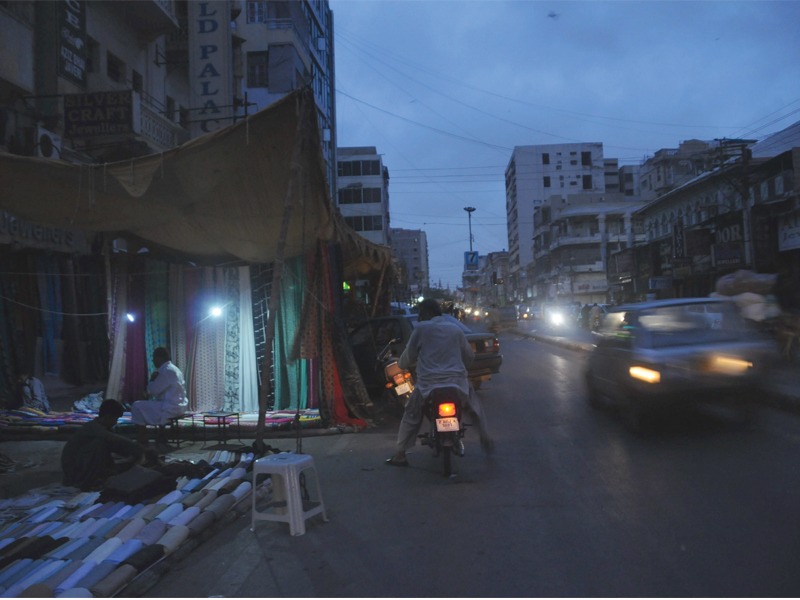 as saddar faces power cuts some shopkeepers have to use small generators to light their shops at night photo mohammad noman express