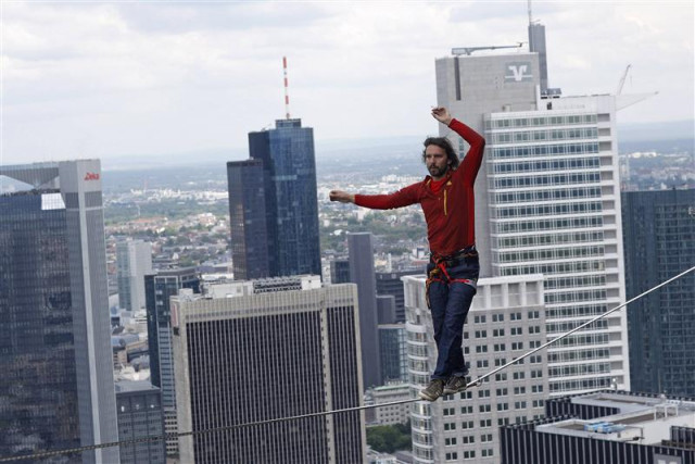 professional slackliner reinhard kleindl walks a high wire in front of the frankfurt skyline may 25 2013 photo reuters professional slackliner reinhard kleindl walks a high wire in front of the frankfurt skyline may 25 2013 photo reuters