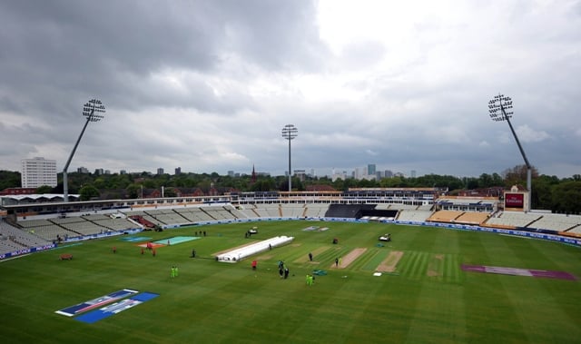 officials inspect the pitch as the wet outfield forces the abandonment of play without a ball being bowled in the warm up cricket match between pakistan and sri lanka photo afp