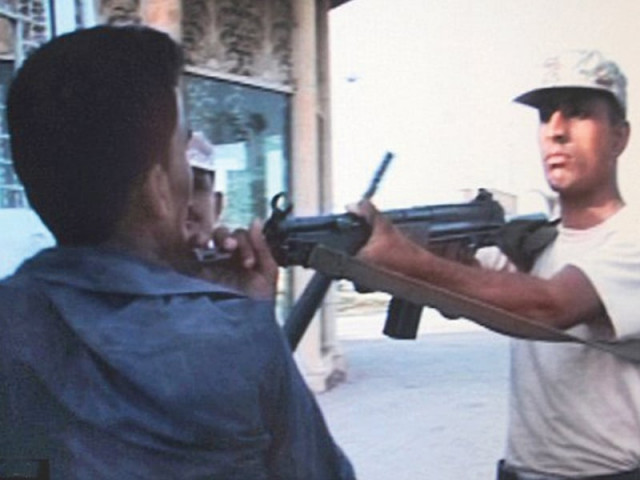 a rangers personnel holds sarfaraz shah at gunpoint before shooting the 19 year old boy the whole episode was captured by a television camera photo file a rangers personnel holds sarfaraz shah at gunpoint before shooting the 19 year old boy the whole episode was captured by a television camera photo file