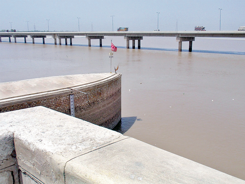 the red flag at the end of the pier between gates 32 and 33 of the sukkur barrage is a spot where the spirit of a saint is said to reside photo express