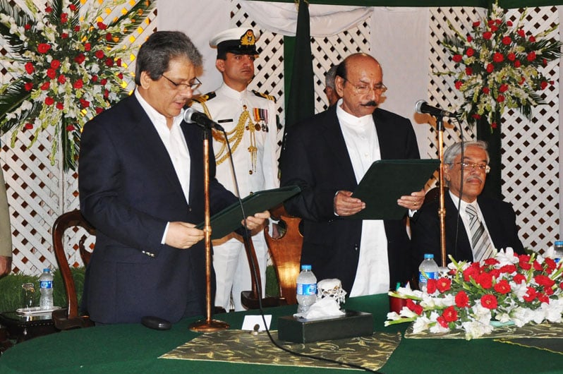 sindh chief minister qaim ali shah is administered the oath by sindh governor ishratul ebad photo mohammad noman express