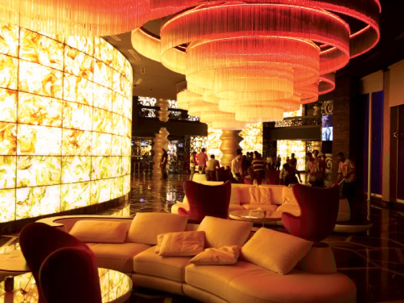 a sitting area inside the building a theatre entrance and concessions area are visible in the background photo express