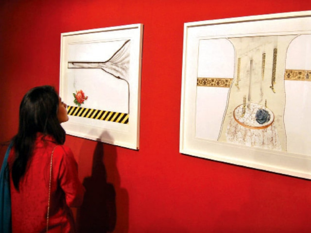 a visitor looking at some of the pieces on display photo muhammad javaid express a visitor looking at some of the pieces on display photo muhammad javaid express