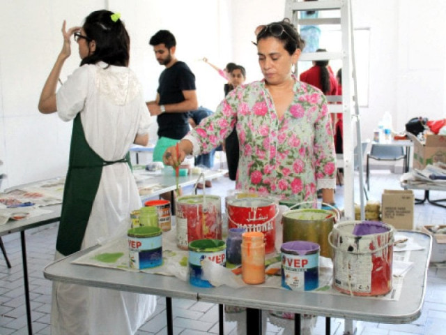 farzana a patient at karwan e hayat mental health facility enjoys painting flowers on the walls of the male dining centre along with ivs students and teachers on saturday afternoon photo express farzana a patient at karwan e hayat mental health facility enjoys painting flowers on the walls of the male dining centre along with ivs students and teachers on saturday afternoon photo express