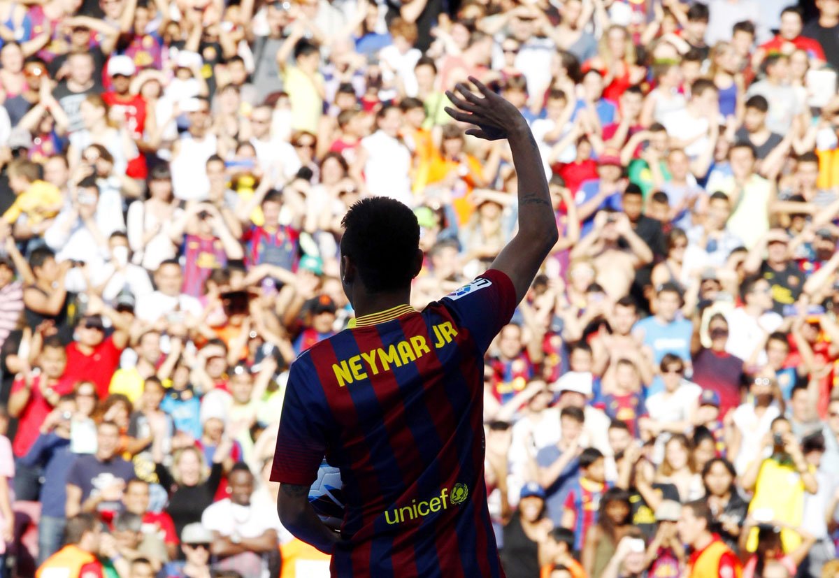 brazilian soccer player neymar waves to barcelona 039 s supporters at his presentation after signing a five year contract with the club at nou camp stadium in barcelona photo reuters