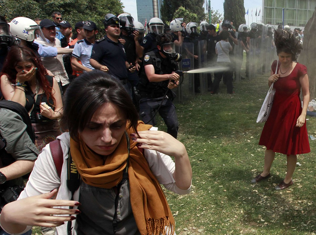 the photo of the woman in the red dress being sprayed by tear gas in istanbul photo reuters