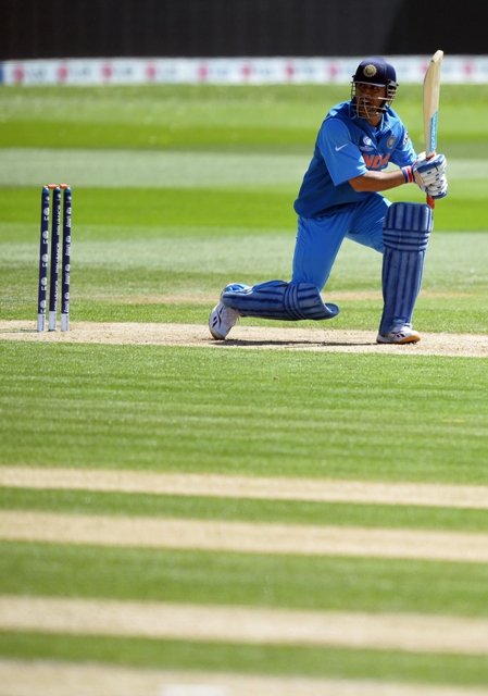 india 039 s captain mahendra singh dhoni looks on after playing a shot during the warm up cricket match photo afp