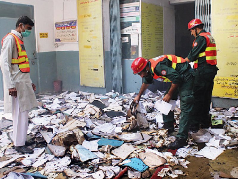 rescue personnel sift through the burnt documents photo online