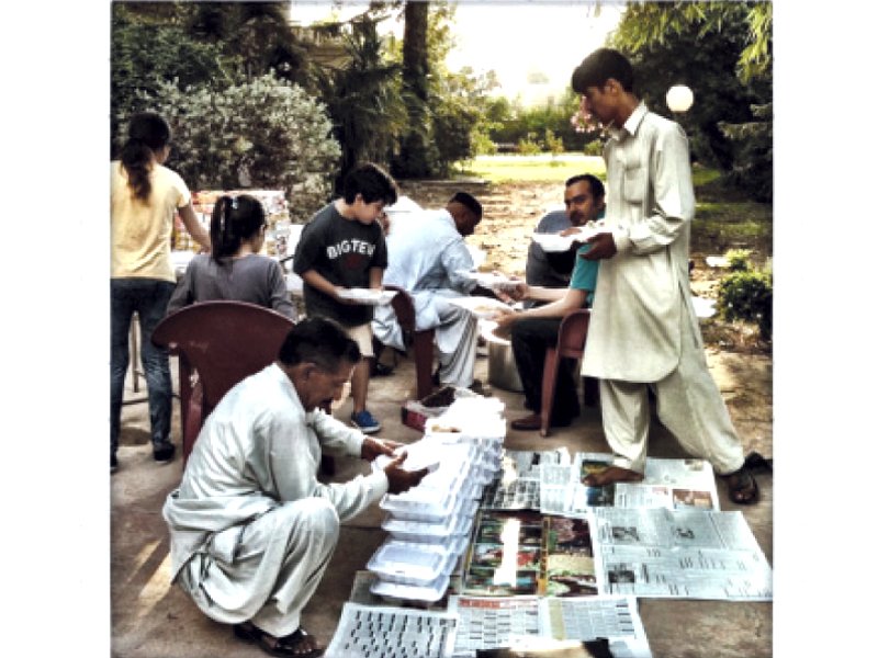 volunteers packing food in lunch boxes photo waqas naeem express