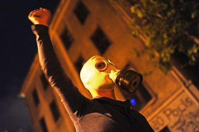 a protestor reacts as they clash with turkish riot policemen on the way to taksim square in istanbul on june 5 2013 as part of ongoing protests against the ruling party police brutality and the destruction of taksim park for a development project photo afp a protestor reacts as they clash with turkish riot policemen on the way to taksim square in istanbul on june 5 2013 as part of ongoing protests against the ruling party police brutality and the destruction of taksim park for a development project photo afp