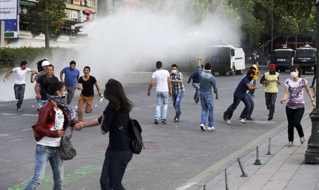 anti government protesters run to take cover to protect themselves from a water canon and tear gas as riot police disperse them during a protest in ankara june 5 2013 photo reuters