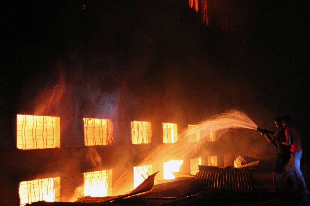 this picture taken on 24 november 2012 shows bangladeshi people and firefighters trying to extinguish a fire in a garment factory in savar 30 kilometres north of dhaka photo afp file