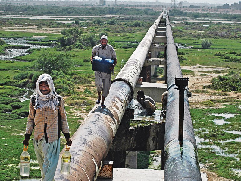 as the temperature soars to over 37 c on thursday people collect water from a broken pipe near korangi crossing photo arif soomro express