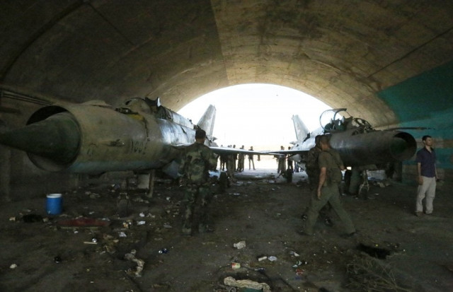 syrian army soldiers stand in the damaged military airport in dabaa north of qusayr in central homs province on june 7 2013 photo afp syrian army soldiers stand in the damaged military airport in dabaa north of qusayr in central homs province on june 7 2013 photo afp