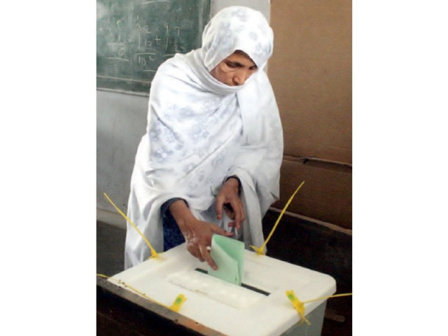 a woman casts her vote in landhi during the re polls held for six polling stations of ps 128 photo inp a woman casts her vote in landhi during the re polls held for six polling stations of ps 128 photo inp