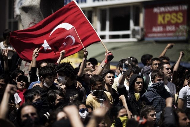 turkish demonstrators hold their national flag on june 4 2013 during a protest in front of the prime minister 039 s office in ankara photo afp