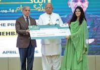 prime minister shehbaz sharif distributes a cheque to a beneficiary during a ceremony in islamabad photo app