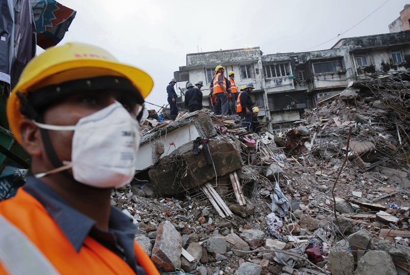 rescue workers search through rubble at the site of a collapsed residential building in mumbai early june 11 2013 photo reuters