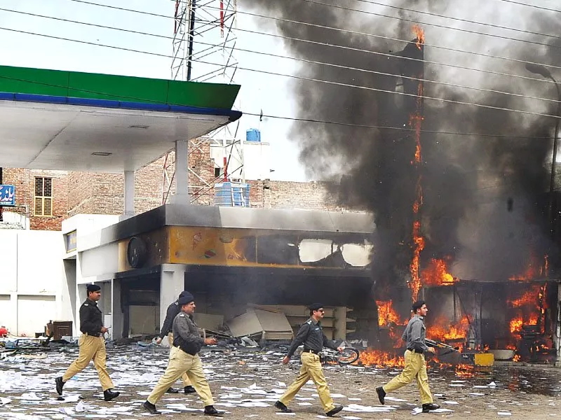 a file photo of a policemen walking across a petrol station gutted in a violent protest related to power issues photo afp a file photo of a policemen walking across a petrol station gutted in a violent protest related to power issues photo afp