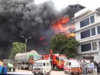 a massive fire engulfs a garment factory in landhi industrial area sending thick plumes of black smoke into the sky and reducing finished goods to ashes photo express a massive fire engulfs a garment factory in landhi industrial area sending thick plumes of black smoke into the sky and reducing finished goods to ashes photo express
