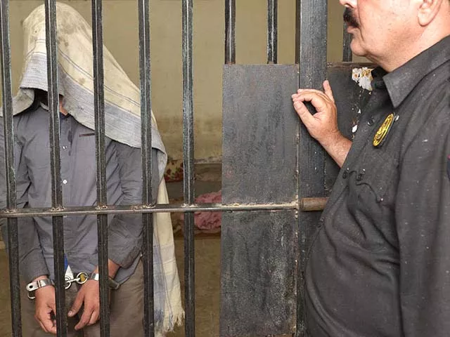 a police officer presents a man arrested on charges of killing homosexual men at a police station in lahore on april 27 2014 photo afp a police officer presents a man arrested on charges of killing homosexual men at a police station in lahore on april 27 2014 photo afp