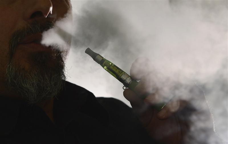 gabor kovacs of 039 smoke no smoke 039 smokes an e cigarette that his shop sells at camden in london june 9 2013 photo reuters