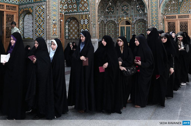 iranian women wait to vote at a polling station at the massoumeh shrine in the holy city of qom photo afp