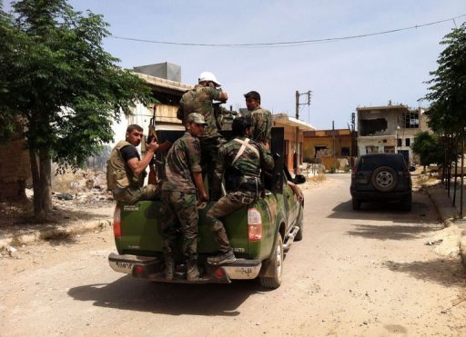 a picture taken on june 7 2013 shows syrian soldiers patrolling a street in the village of buweida north of qusayr photo afp