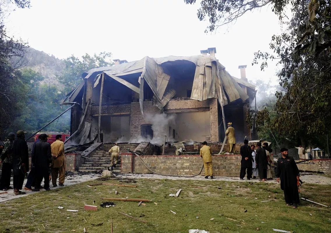 security personnel gather as firefighters extinguish a blaze which gutted the national monument in ziarat photo afp security personnel gather as firefighters extinguish a blaze which gutted the national monument in ziarat photo afp
