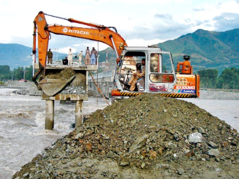 khyber pakhtunkhwa highway authority officials repair the khawazakhela bridge which partially collapsed due to flooding in swat river photo online