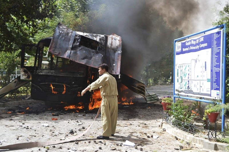 a firefighter stands near a burning bus after a bomb attack in quetta june 15 2013 photo reuters