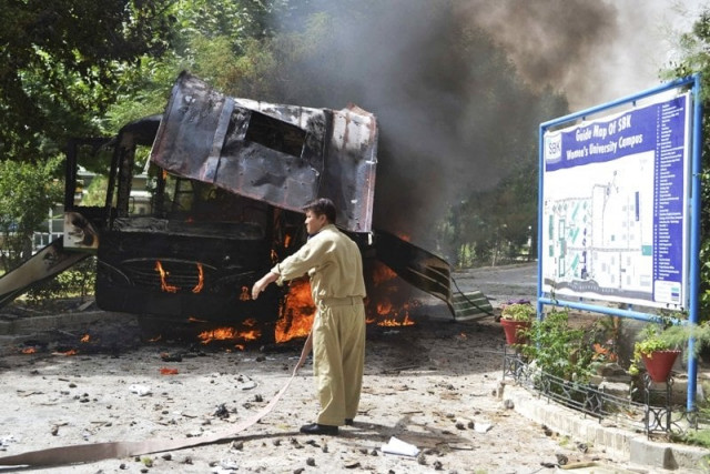 a firefighter stands near a burning bus after a bomb attack in quetta june 15 2013 photo reuters a firefighter stands near a burning bus after a bomb attack in quetta june 15 2013 photo reuters
