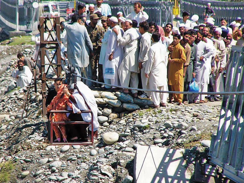 after the recent flooding in river swat left ayub bridge partially damaged residents have started using cable car to travel from kabal tehsil to mingora photo online