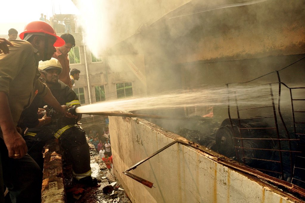 bangladeshi firefighters try and control a fire that broke out at a garment factory on the outskirts of dhaka on november 26 2012 photo afp