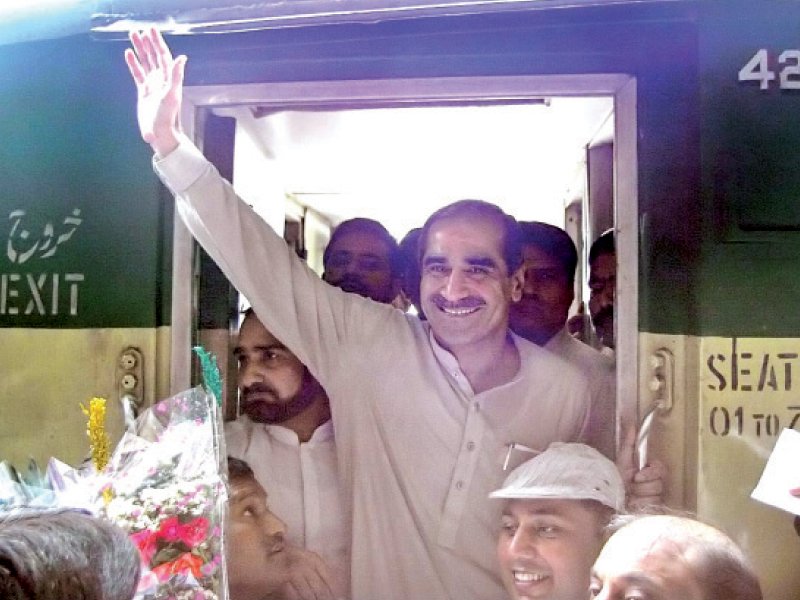 railways minister khwaja saad rafiq waving to railway employees upon his arrival at rawalpindi photo app