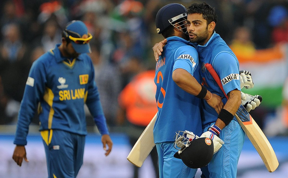 india 039 s virat kohli r and india 039 s suresh raina c embrace after securing victory in the 2013 icc champions trophy semi final cricket match between india and sri lanka photo afp