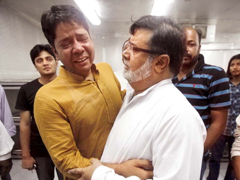 brothers of mpa sajid qureshi comfort each other at a morgue photo reuters