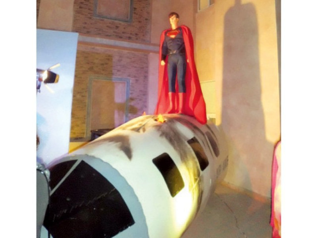the model superman stands atop the aeroplane s remains photo vaqas asghar express the model superman stands atop the aeroplane s remains photo vaqas asghar express