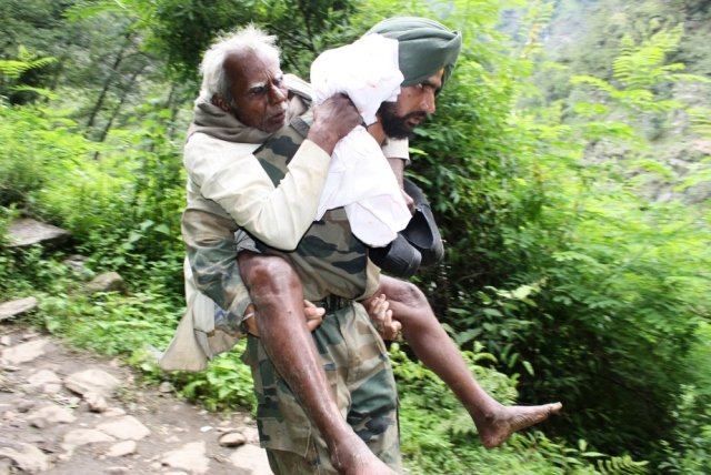 in this handout photograph released by the indian ministry of defence indian military personnel help rescue pilgrims that were stranded by flood waters in uttarakhand state on june 22 2013 photo afp ministry of defence