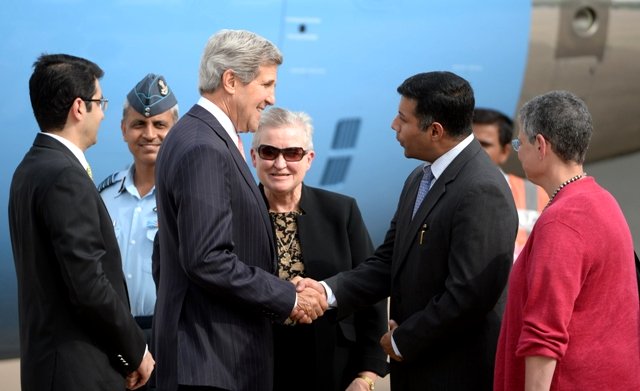 us secretary of state john kerry c is greeted by an indian diplomat as he arrives at palam air force station while us ambassador to india nancy j powell l looks on in new delhi on june 23 2013 photo afp