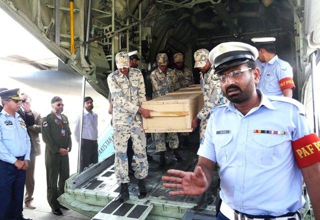 pakistani air force personnel carry coffins of foreign tourists as they are unloaded from a c 130 air plane upon arrival at chaklala airbase in rawalpindi on june 23 2013 photo afp