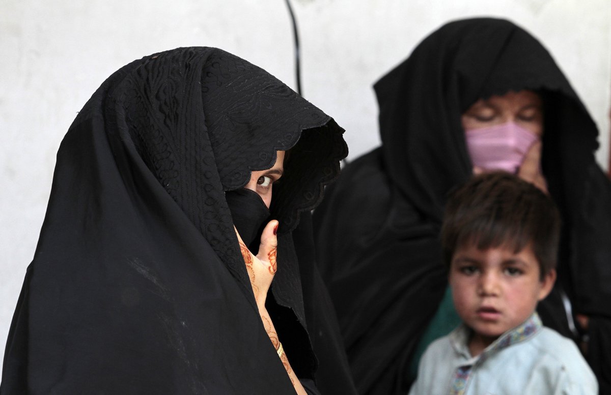 a woman sits with others while waiting her turn to receive fortified food supplements at a centre for malnourished women and children during a visit by the executive director of the wfp in baidara in swat valley photo reuters